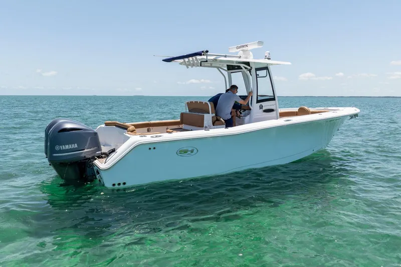 Slide: The Image of 2021 Sea Hunt Ultra 275 SE boat on clear blue water, featuring Yamaha engine. - 9
