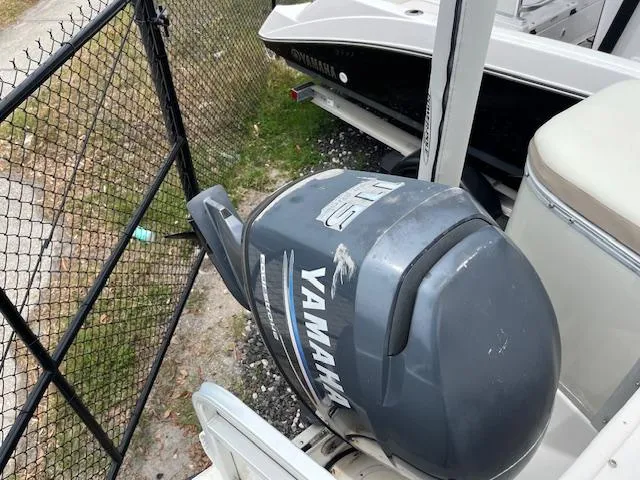Slide: The Image of Yamaha outboard motor on a 2004 Hurricane FD196RE boat near a fence. - 10