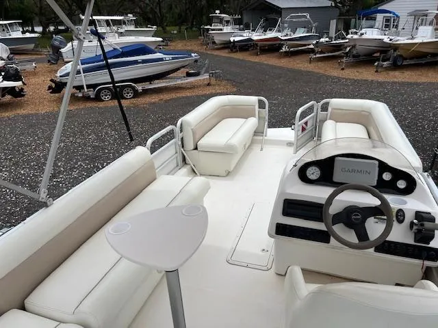 Slide: The Image of 2004 Hurricane FD196RE boat interior with white seating and steering console. - 12