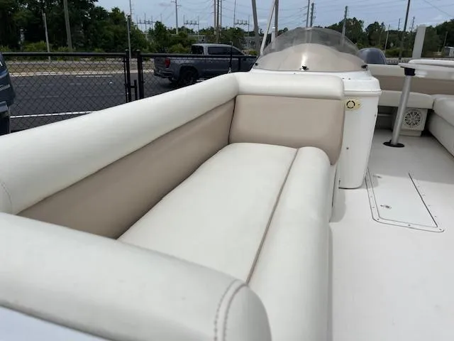 Slide: The Image of 2004 Hurricane FD196RE boat with white cushioned seating, parked outdoors. - 4