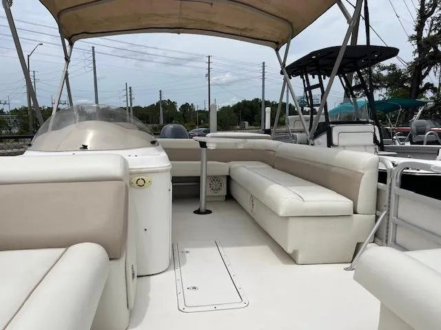 Slide: The Image of 2004 Hurricane FD196RE boat interior with beige seating and canopy. - 6