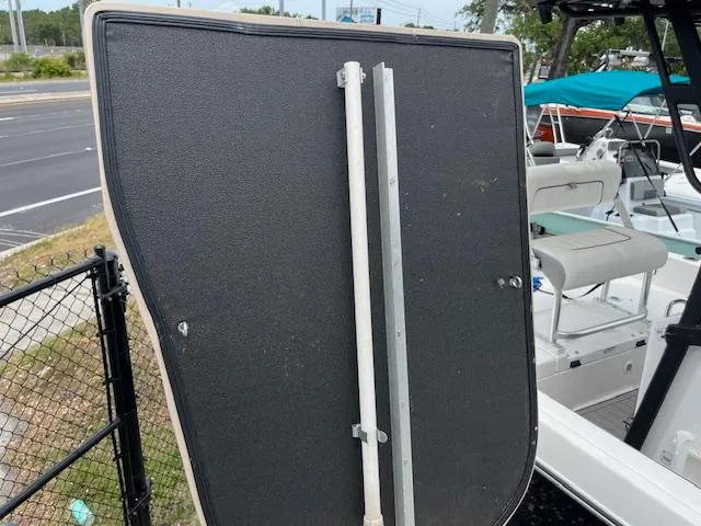 Slide: The Image of Boat seat backrest on a 2004 Hurricane FD196RE, near a fence and road. - 9