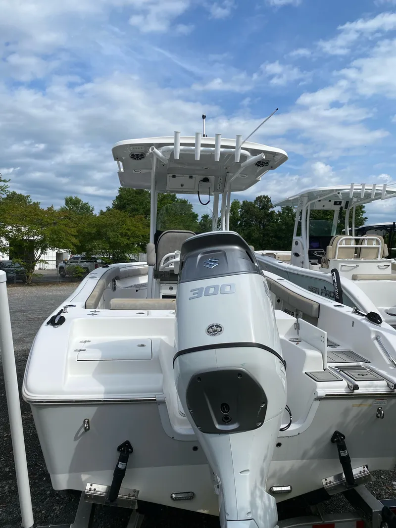 Slide: The Image of 2021 Sea Pro 239 Center Console boat with powerful 300 HP engine, docked outdoors. - 1
