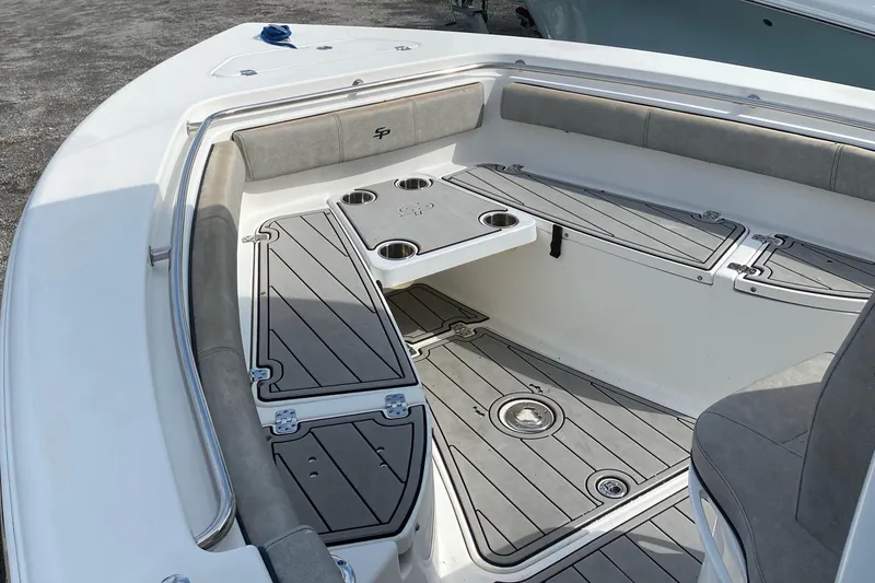 Slide: The Image of 2021 Sea Pro 239 Center Console boat interior with cushioned seating and cup holders. - 2