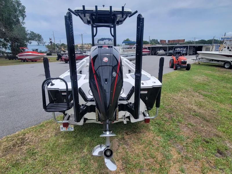 Slide: The Image of 2024 Blazer Bay 2440 boat with powerful outboard motor, parked on grass. - 3