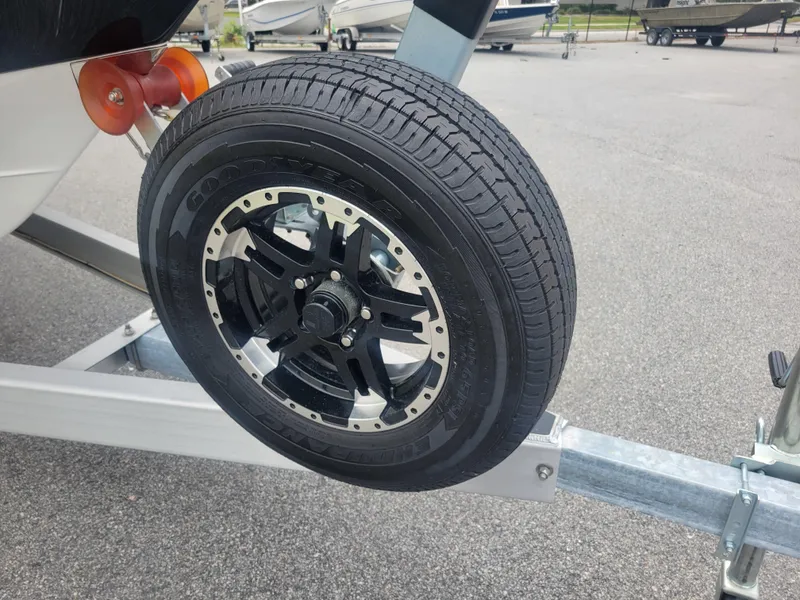 Slide: The Image of Trailer wheel of 2024 Blazer Bay 2440 boat on asphalt surface. - 34