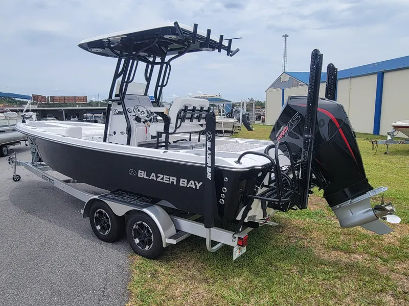 Slide: The Image of 2024 Blazer Bay 2440 boat on trailer, black hull, outdoor display. - 4