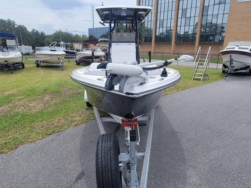 Slide: The Image of 2024 Blazer Bay 2440 boat on trailer, parked outdoors near other boats. - 6
