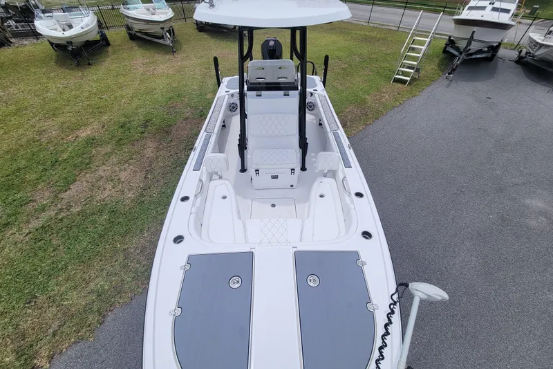 Slide: The Image of 2024 Blazer Bay 2440 boat, aerial view, parked on grass and pavement. - 8