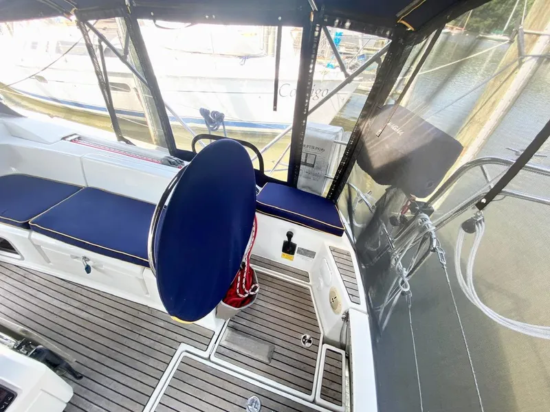 Slide: The Image of Cockpit of 2016 Jeanneau Sun Odyssey 479 sailboat with blue seating and wooden flooring. - 44
