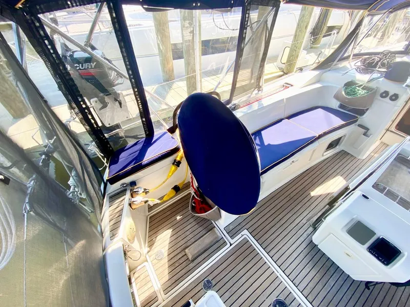 Slide: The Image of 2016 Jeanneau Sun Odyssey 479 cockpit with blue seating and wooden flooring. - 45