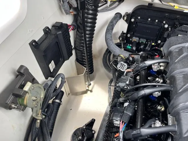 Slide: The Image of Engine compartment of a 2021 Yamaha Boats 212XE, showcasing wiring and components. - 11