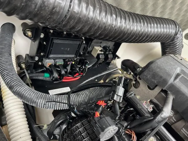 Slide: The Image of Engine compartment of a 2021 Yamaha Boats 212XE, showcasing wiring and components. - 12