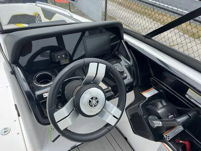 Slide: The Image of 2021 Yamaha Boats 212XE steering console with modern controls and display. - 8