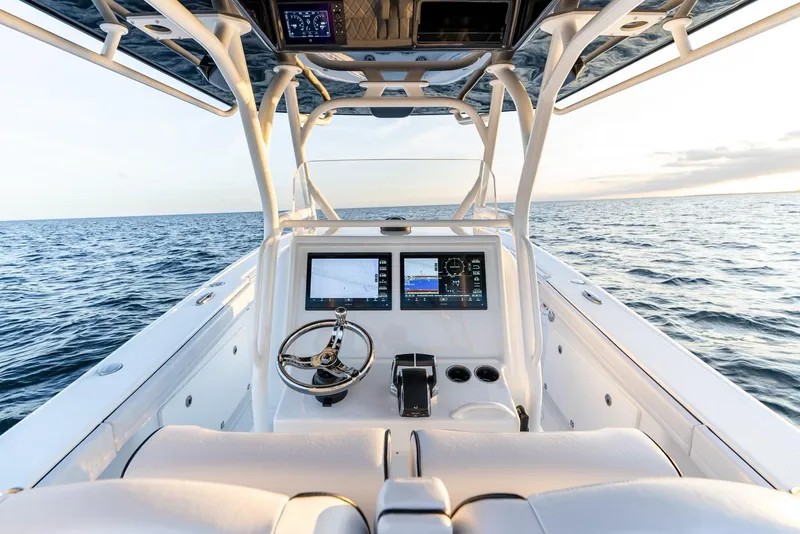 Slide: The Image of 2023 Yellowfin 34 boat dashboard with ocean view, featuring modern navigation equipment. - 13