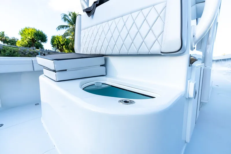 Slide: The Image of 2023 Yellowfin 34 boat interior with cushioned seating and storage compartment. - 24