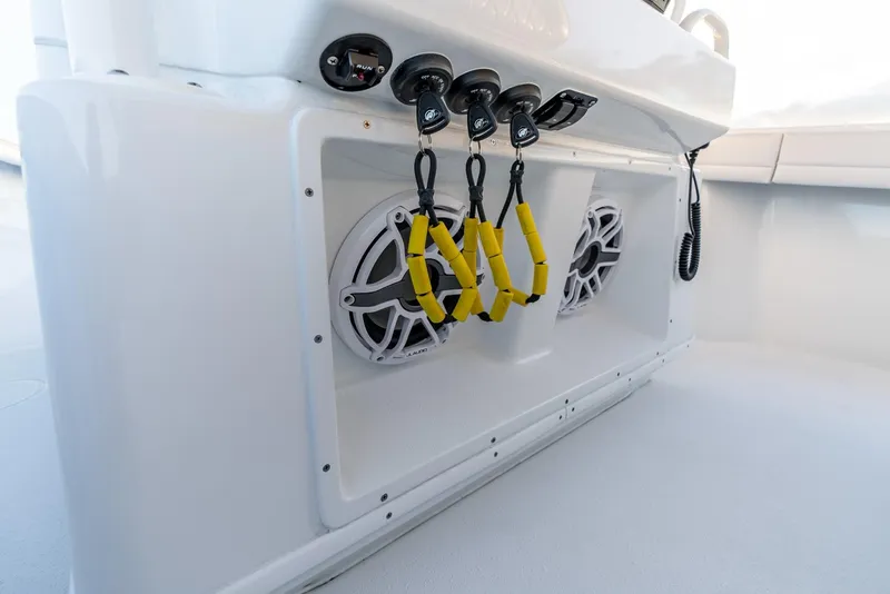 Slide: The Image of 2023 Yellowfin 34 boat console with speakers and yellow handle grips. - 25