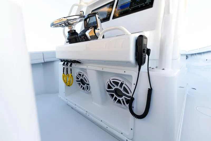 Slide: The Image of 2023 Yellowfin 34 boat console with steering wheel, speakers, and electronic controls. - 26