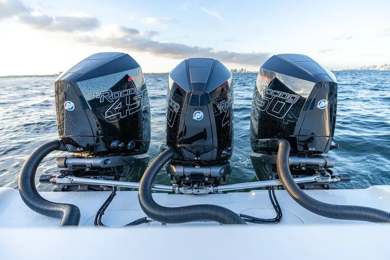 Slide: The Image of Triple Mercury Racing 450R engines on a 2023 Yellowfin 34 boat in open water. - 27