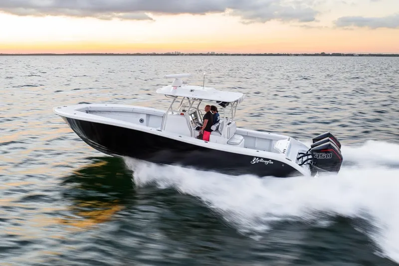 Slide: The Image of 2023 Yellowfin 34 boat cruising on open water at sunset. - 3