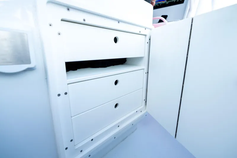 Slide: The Image of 2023 Yellowfin 34 boat storage compartment with open drawers. - 31