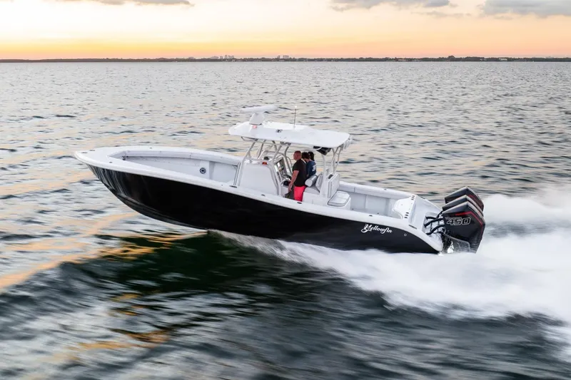 Slide: The Image of 2023 Yellowfin 34 boat cruising on water at sunset. - 4