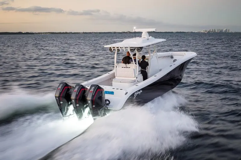 Slide: The Image of 2023 Yellowfin 34 boat speeding on open water at sunset. - 5