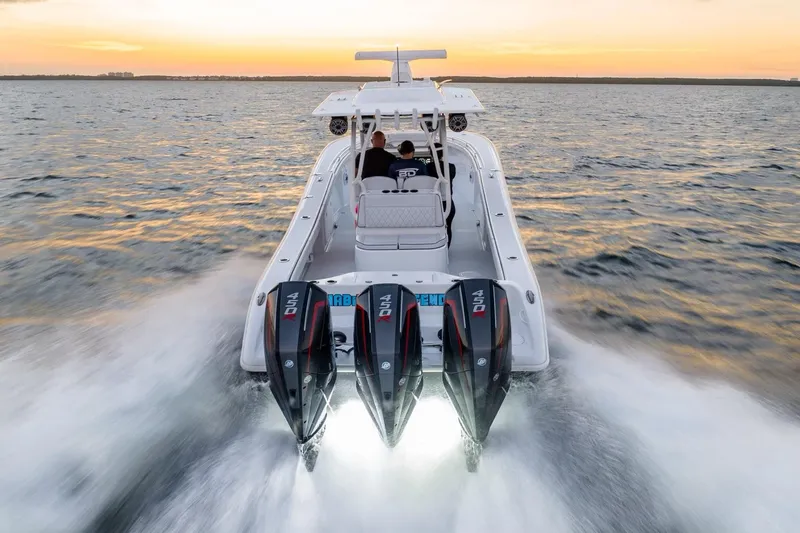 Slide: The Image of 2023 Yellowfin 34 boat cruising at sunset with powerful engines on open water. - 6