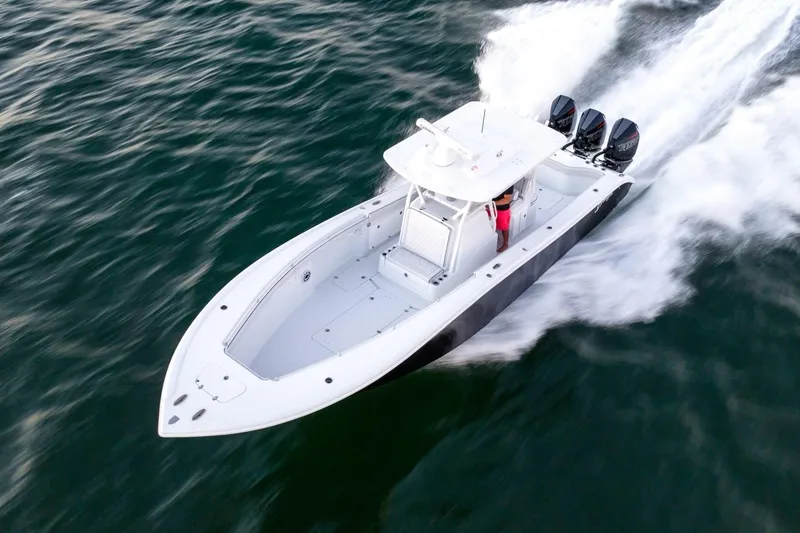 Slide: The Image of 2023 Yellowfin 34 boat speeding on open water, showcasing sleek design and powerful engines. - 7