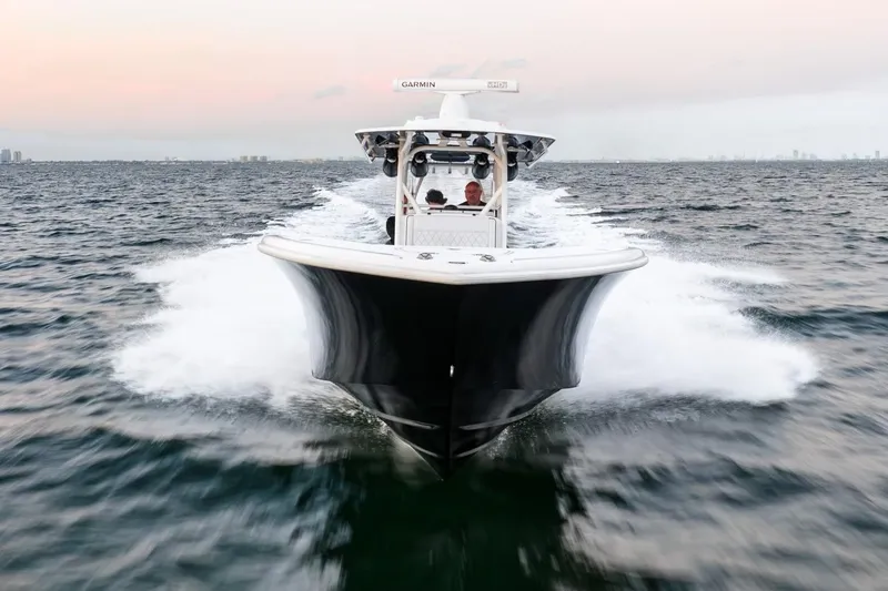 Slide: The Image of 2023 Yellowfin 34 boat cruising on open water at sunset. - 8