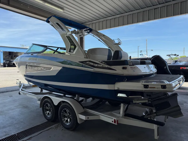 Slide: The Image of 2017 Regal 2300 RX Surf boat on trailer in covered area. - 13