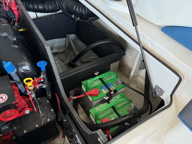 Slide: The Image of Engine compartment of a 2017 Regal 2300 RX Surf boat with visible batteries and components. - 15