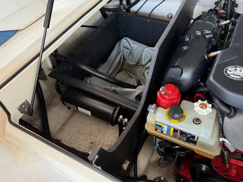 Slide: The Image of Engine compartment of a 2017 Regal 2300 RX Surf boat, showcasing mechanical components. - 16