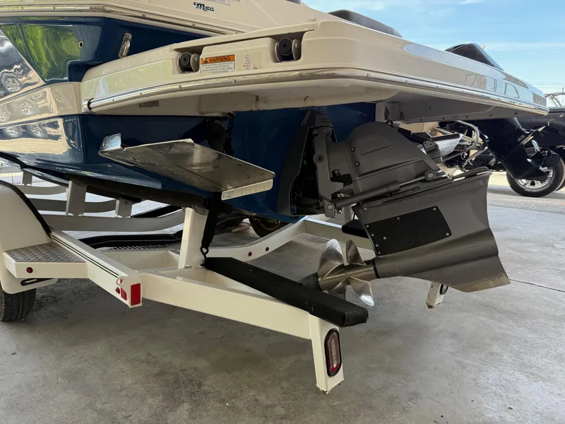 Slide: The Image of 2017 Regal 2300 RX Surf boat on trailer, showcasing propeller and hull design. - 5