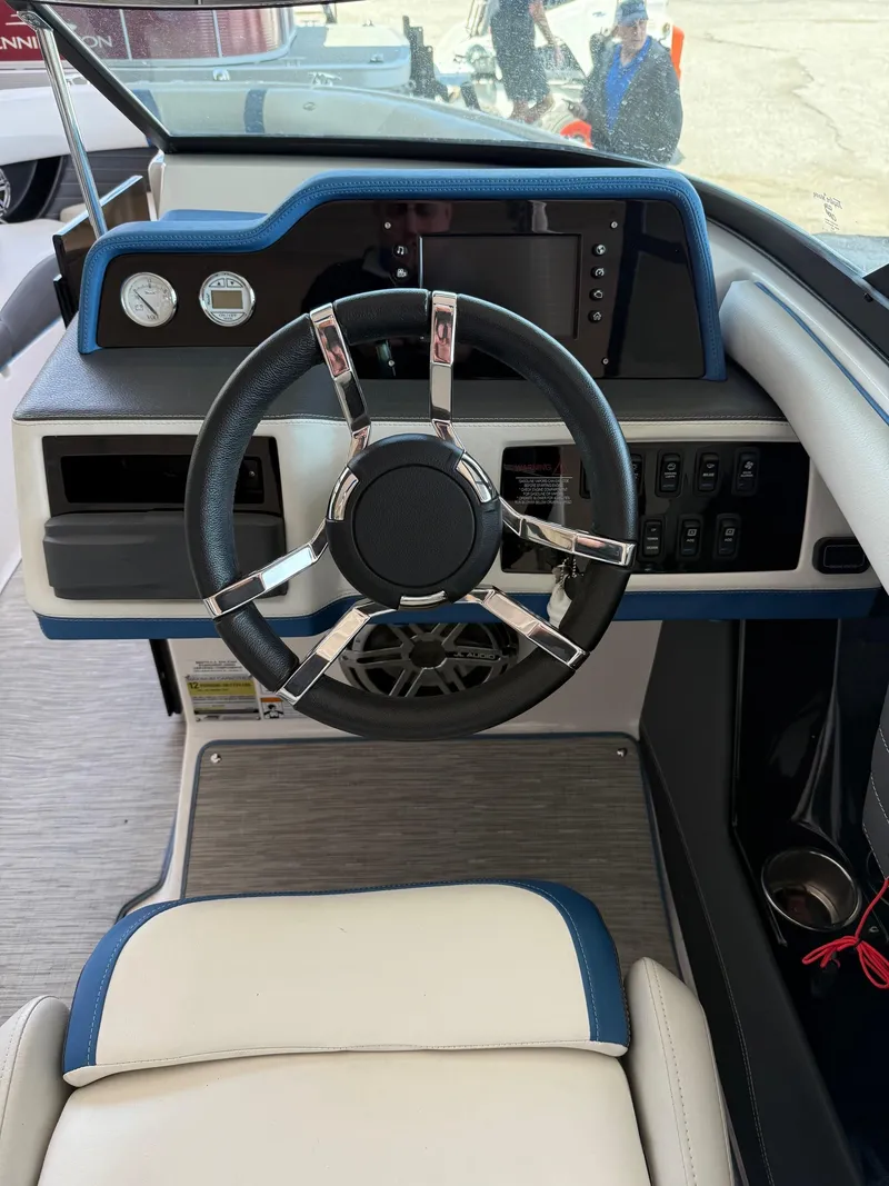 Slide: The Image of 2017 Regal 2300 RX Surf boat dashboard with steering wheel and controls. - 9