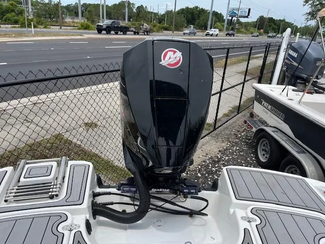 Slide: The Image of Outboard motor on a 2023 Tahoe 1950 boat, parked near a busy road. - 7