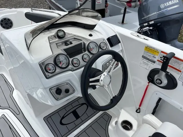 Slide: The Image of Control panel of a 2023 Tahoe 1950 boat with steering wheel and gauges. - 8