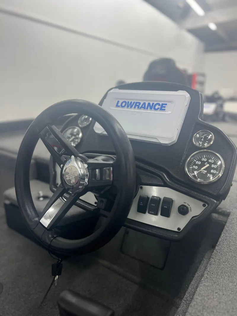 Slide: The Image of 2024 Ranger RT188P boat dashboard with Lowrance display and steering wheel. - 13