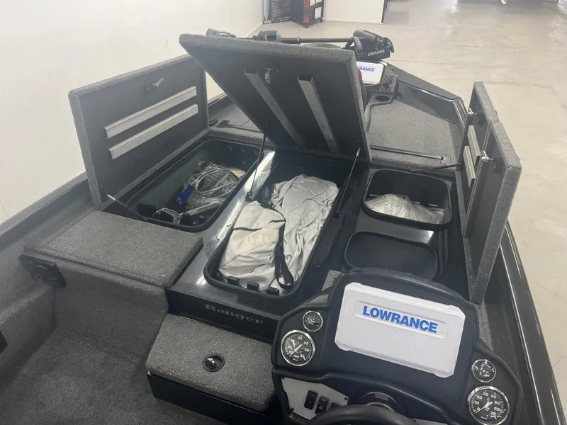 Slide: The Image of 2024 Ranger RT188P boat interior with storage compartments and Lowrance electronics. - 14