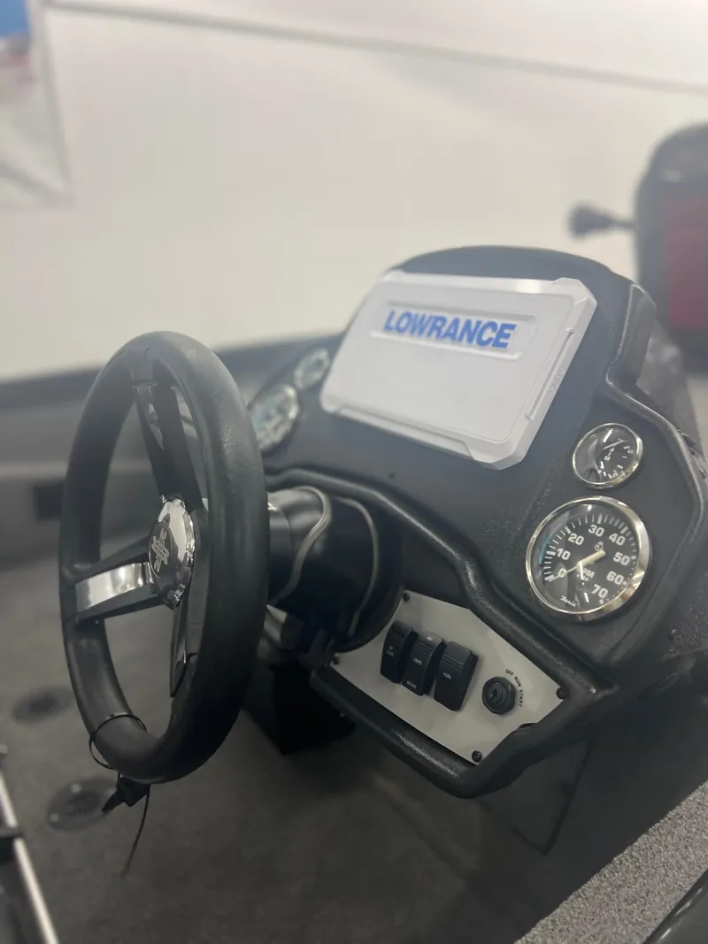 Slide: The Image of 2024 Ranger RT188P boat dashboard with Lowrance display and steering wheel. - 15