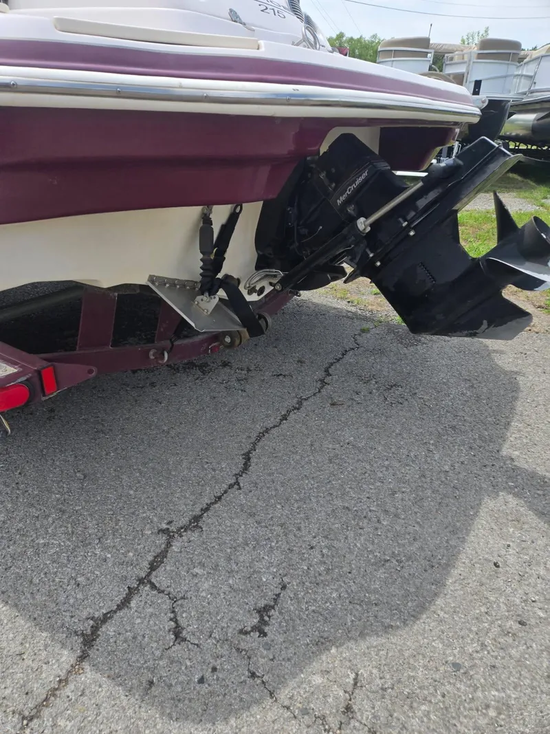 Slide: The Image of 2008 Tahoe 215 I/O boat rear view with outboard motor on pavement. - 11