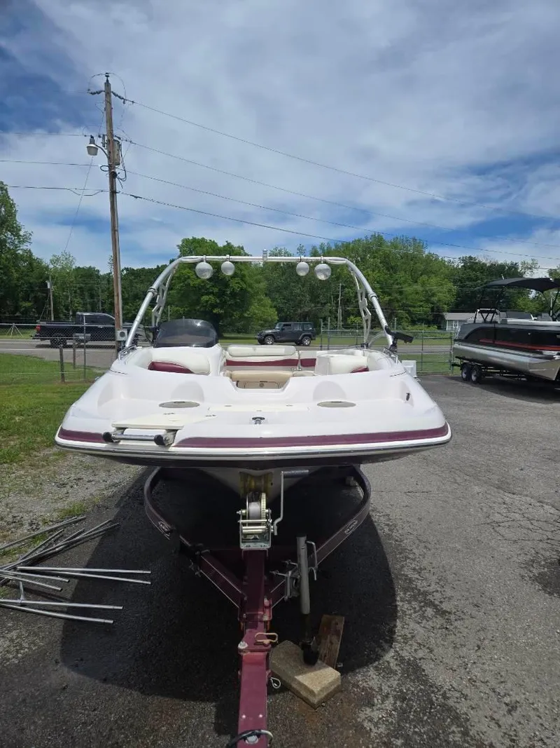 Slide: The Image of 2008 Tahoe 215 I/O boat on trailer, parked outdoors under a partly cloudy sky. - 3
