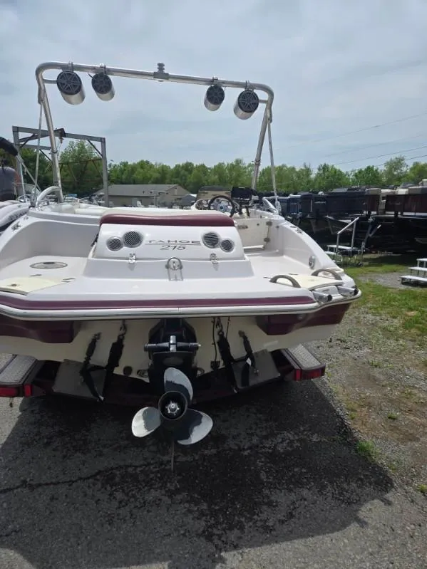 Slide: The Image of 2008 Tahoe 215 I/O boat with speakers, parked outdoors. - 4