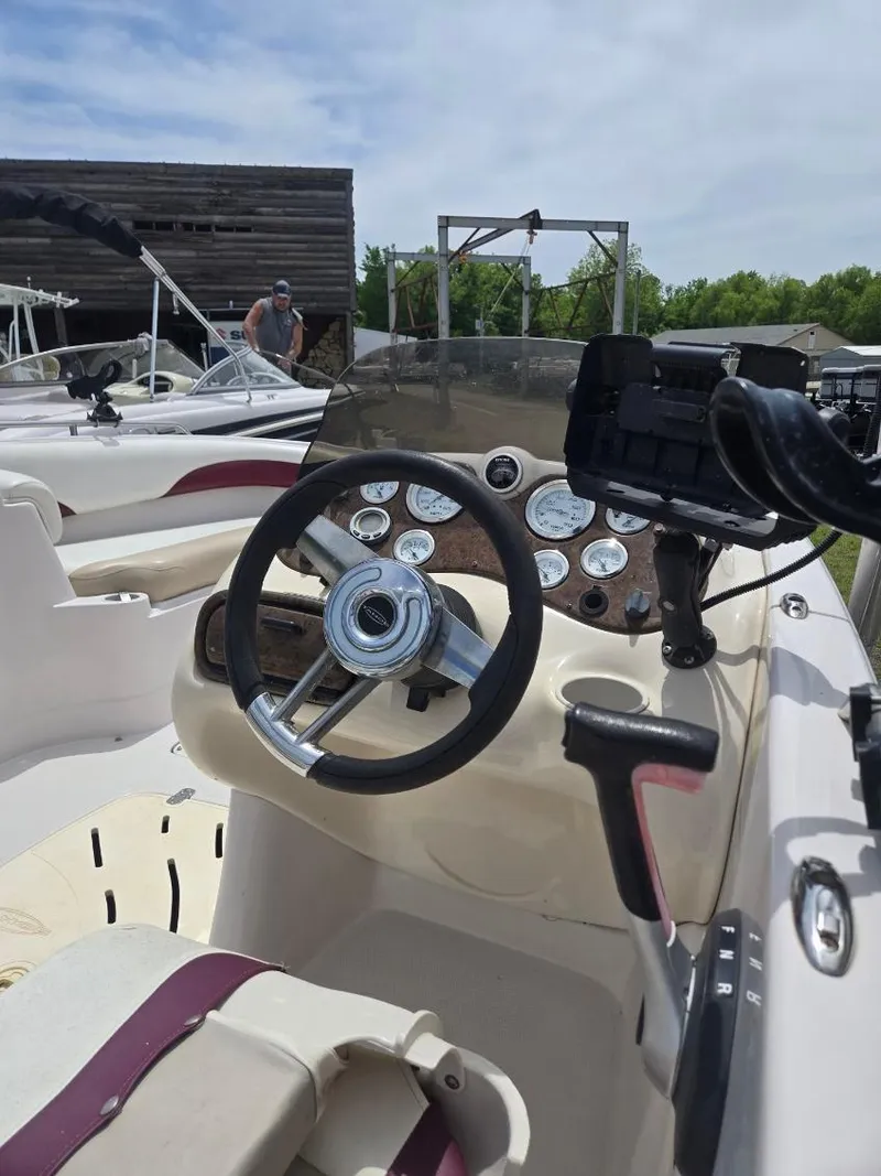 Slide: The Image of 2008 Tahoe 215 I/O boat dashboard with steering wheel and gauges. - 8