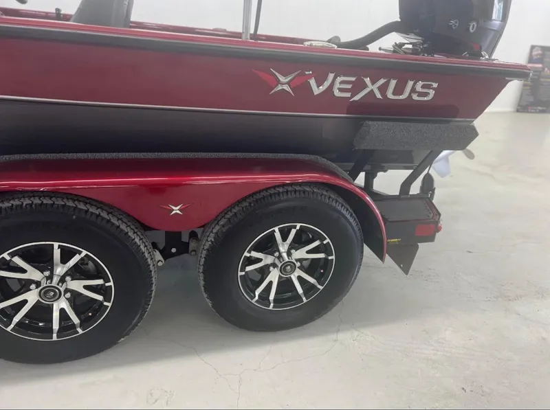 Slide: The Image of 2021 Vexus 2080 boat on trailer, featuring dual wheels and sleek red design. - 10