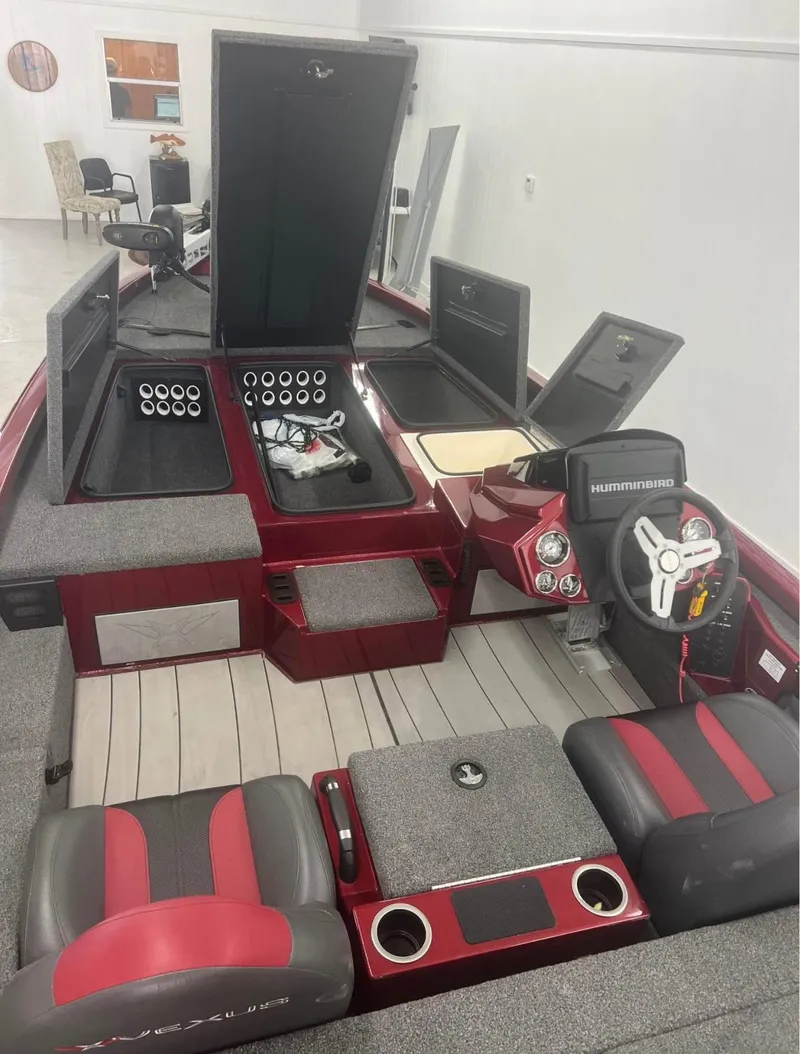 Slide: The Image of 2021 Vexus 2080 boat interior with red and gray seating, storage compartments, and Humminbird electronics. - 11