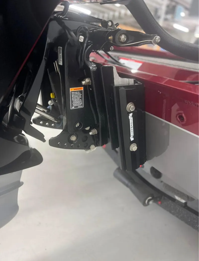 Slide: The Image of Close-up of a 2021 Vexus 2080 boat motor mount in a garage setting. - 13