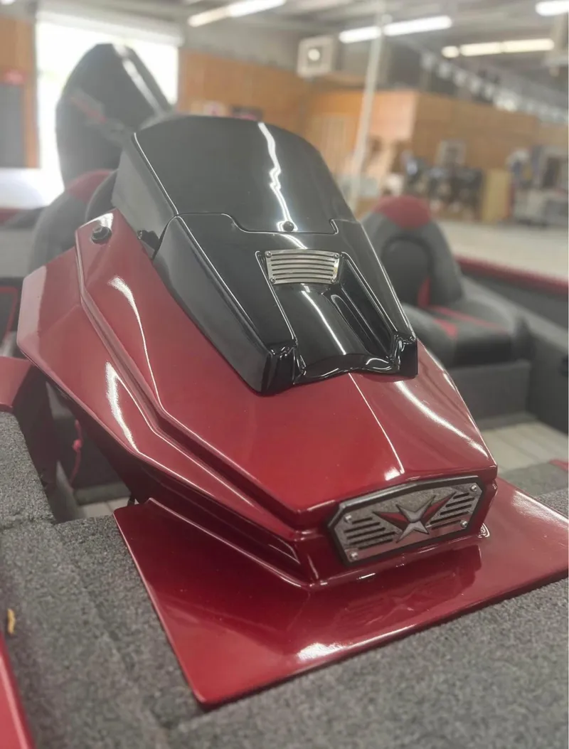 Slide: The Image of 2021 Vexus 2080 boat console, featuring sleek red and black design in showroom setting. - 5