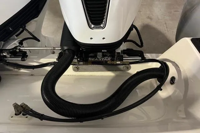 Slide: The Image of Engine compartment of 2022 Fluid Watercraft Patrol 880 Cabin with visible hoses and components. - 11