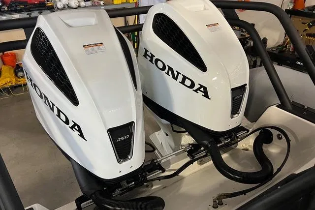 Slide: The Image of Twin Honda 250 outboard engines on a 2022 Fluid Watercraft Patrol 880 Cabin boat. - 9